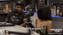 A conversation between two people, one asking, 'So... What now?' while the other listens, both sitting in a studio with microphones.